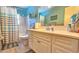 Bathroom featuring a shower, vanity, and framed beach-themed artwork at 5385 Avenida Del Mare, Sarasota, FL 34242
