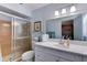 Bright bathroom featuring a shower with glass doors and a large vanity at 5385 Avenida Del Mare, Sarasota, FL 34242