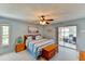 Bright bedroom featuring blue walls, queen bed with striped bedding, and access to sunroom at 5385 Avenida Del Mare, Sarasota, FL 34242