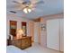 Bedroom featuring a ceiling fan, dresser with mirrors, and a closet at 5385 Avenida Del Mare, Sarasota, FL 34242