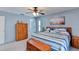 Cozy bedroom featuring blue walls, ceiling fan, and queen bed with striped bedding at 5385 Avenida Del Mare, Sarasota, FL 34242