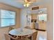 Open-concept dining area with wicker table and chairs situated adjacent to a functional kitchen at 5385 Avenida Del Mare, Sarasota, FL 34242