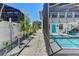 Exterior view from walkway between houses featuring a blue door and a screened in pool at 5385 Avenida Del Mare, Sarasota, FL 34242