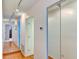Hallway with hardwood floors and mirrored closet doors at 5385 Avenida Del Mare, Sarasota, FL 34242
