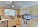 The kitchen features ample countertop space, modern appliances, and bright overhead lighting with ceiling fan at 5385 Avenida Del Mare, Sarasota, FL 34242