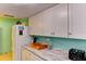 Bright kitchen with white cabinets, marbled countertops, and modern appliances at 5385 Avenida Del Mare, Sarasota, FL 34242