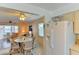 Open-concept kitchen with white refrigerator and view into dining area and living room at 5385 Avenida Del Mare, Sarasota, FL 34242