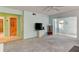 Living room with television, leading to enclosed patio area, bathroom, and spare room at 5385 Avenida Del Mare, Sarasota, FL 34242