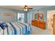 Main bedroom with an ensuite office, dresser with mirror, and light blue walls at 5385 Avenida Del Mare, Sarasota, FL 34242