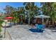 Outdoor patio area with tables, chairs, and lush landscaping, perfect for entertaining at 5385 Avenida Del Mare, Sarasota, FL 34242