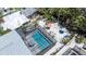 Aerial view of a screened-in pool area with outdoor seating and lush landscaping at 5385 Avenida Del Mare, Sarasota, FL 34242
