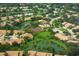 Aerial view of neighborhood with lake and tennis courts at 6096 Wilshire Blvd # 9, Sarasota, FL 34238