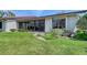 Well-maintained backyard with lush green grass and a charming patio area at 6096 Wilshire Blvd # 9, Sarasota, FL 34238