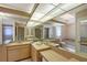 Bright bathroom features a double vanity with mirror, shower, and soaking tub at 6096 Wilshire Blvd # 9, Sarasota, FL 34238
