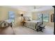 Bedroom featuring carpet flooring, ceiling fan and lots of natural light at 6096 Wilshire Blvd # 9, Sarasota, FL 34238