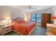 Cozy bedroom with a ceiling fan, large window, and vintage furnishings at 6096 Wilshire Blvd # 9, Sarasota, FL 34238