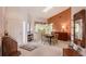 Dining room with high ceiling, earth-tone decor, and access to kitchen at 6096 Wilshire Blvd # 9, Sarasota, FL 34238