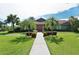 Charming home with tile roof, lush lawn, and colorful front garden at 6096 Wilshire Blvd # 9, Sarasota, FL 34238