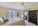 Main bedroom with carpet flooring, ceiling fan, large window and water views at 6096 Wilshire Blvd # 9, Sarasota, FL 34238