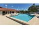 Community pool with many tables and chairs for residents at 6096 Wilshire Blvd # 9, Sarasota, FL 34238