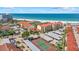 Aerial view featuring beachfront condos, a tennis court, and beach access at 6204 Midnight Pass Rd # 201, Sarasota, FL 34242