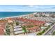 Aerial view of beachfront condos with red tile roofs overlooking the ocean at 6204 Midnight Pass Rd # 201, Sarasota, FL 34242