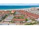 Aerial view of beachfront condos with red tile roofs near the beach at 6204 Midnight Pass Rd # 201, Sarasota, FL 34242