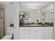 Bathroom features a white vanity with a dark countertop and an oversized mirror at 6204 Midnight Pass Rd # 201, Sarasota, FL 34242