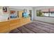 Spacious bedroom with a dresser, an ensuite bath, and large sunny windows at 6204 Midnight Pass Rd # 201, Sarasota, FL 34242