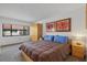 Bedroom showcasing a warm color scheme, large windows, and ample closet space at 6204 Midnight Pass Rd # 201, Sarasota, FL 34242