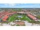 An aerial view of community buildings, green space, beach access, and a tranquil community pool at 6204 Midnight Pass Rd # 201, Sarasota, FL 34242