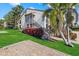 Condo exterior featuring lush landscaping and a welcoming walkway at 6204 Midnight Pass Rd # 201, Sarasota, FL 34242