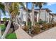 Attractive condo building featuring lush landscaping, brick paved entrance and stairs on a sunny day at 6204 Midnight Pass Rd # 201, Sarasota, FL 34242