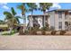 Condo exterior boasting lush landscaping, complemented by swaying palm trees at 6204 Midnight Pass Rd # 201, Sarasota, FL 34242