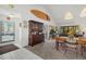 Open-concept living and dining area with tile entry, vaulted ceilings and a view to the balcony at 6204 Midnight Pass Rd # 201, Sarasota, FL 34242