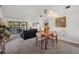 Open-concept living room featuring neutral carpet, vaulted ceilings, and a view to the balcony at 6204 Midnight Pass Rd # 201, Sarasota, FL 34242