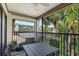 Relaxing outdoor patio offering a table set with palm tree views at 6204 Midnight Pass Rd # 201, Sarasota, FL 34242