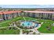 A beautiful community pool surrounded by lush tropical landscaping and well-manicured lawn at 6204 Midnight Pass Rd # 201, Sarasota, FL 34242