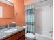 Colorful bathroom with granite countertop, tile flooring and shower-tub combination at 635 N Jefferson Ave # 635, Sarasota, FL 34237