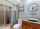 Modern bathroom featuring granite countertops, a unique sink, and shower with access to outside at 635 N Jefferson Ave # 635, Sarasota, FL 34237