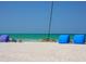 Scenic beach view with calm turquoise waters, a catamaran, and beach canopies under a clear blue sky at 635 N Jefferson Ave # 635, Sarasota, FL 34237
