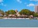 Beachfront restaurant on a sunny day, with palm trees, thatched roofs and an inviting view at 635 N Jefferson Ave # 635, Sarasota, FL 34237