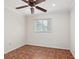 Neutral bedroom with tile flooring, white walls, and a ceiling fan at 635 N Jefferson Ave # 635, Sarasota, FL 34237