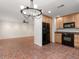 Bright kitchen featuring wood cabinets, black appliances, and a modern chandelier at 635 N Jefferson Ave # 635, Sarasota, FL 34237