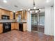 Well-lit kitchen with light wooden cabinets, black appliances, and a sliding glass door leading to outdoor area at 635 N Jefferson Ave # 635, Sarasota, FL 34237