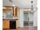 Kitchen boasts light wood cabinetry, granite countertops, black appliances, and a chandelier over the adjacent dining area at 635 N Jefferson Ave # 635, Sarasota, FL 34237