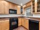This kitchen features light wooden cabinets, black appliances, tile flooring, and an overhead microwave oven at 635 N Jefferson Ave # 635, Sarasota, FL 34237