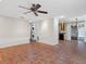 Open living room with tiled flooring, a ceiling fan, and access to a washer and dryer at 635 N Jefferson Ave # 635, Sarasota, FL 34237