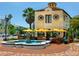 Charming outdoor restaurant with fountain, yellow umbrellas and diners at tables at 635 N Jefferson Ave # 635, Sarasota, FL 34237