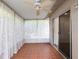 Enclosed sunroom with tile flooring, sheer curtains, and sliding glass door at 635 N Jefferson Ave # 635, Sarasota, FL 34237